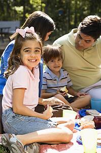 Girl with family picnicking in the park