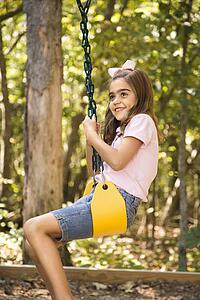 Girl swinging and smiling