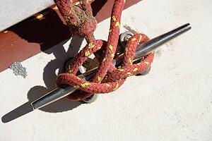 Red rope tied around handle on side of boat