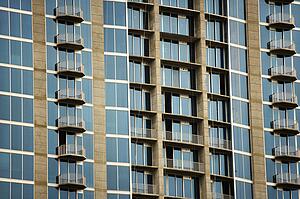 Exterior of high rise building with mirrored windows and balconies