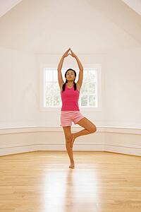 Woman balancing in yoga tree pose