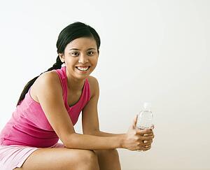 Woman holding bottle of water