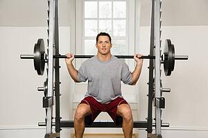 Man lifting weights in gym.