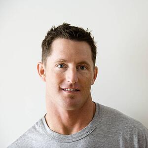 Head and shoulder portrait of man in t-shirt against white wall