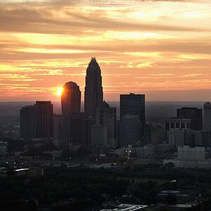 Aerial view of sunset behind city skyline of Charlotte, North Carolina