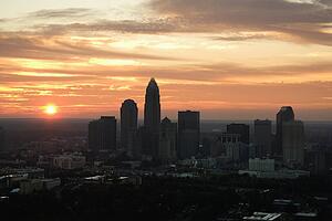 Aerial view of sunset behind city skyline of Charlotte, North Carolina.
