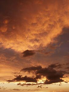 Beautiful clouds in orange-yellow sky