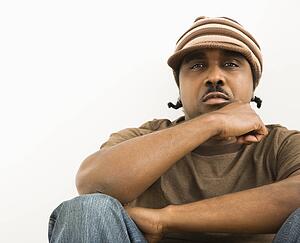 African-American mid-adult man wearing hat looking at viewer.