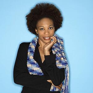 Pretty woman smiling against blue background.