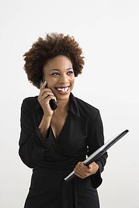 Businesswoman talking on cellphone smiling