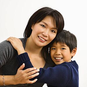 Mother and son hugging and smiling
