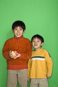 Boys holding apple smiling