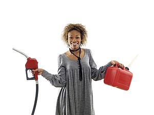 Woman holding fuel pump nozzle and gas storage container