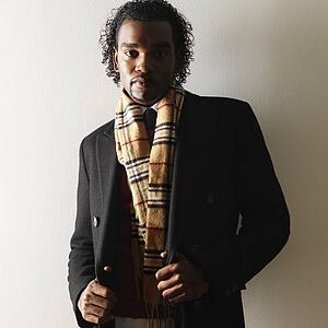 Man in dress attire and scarf