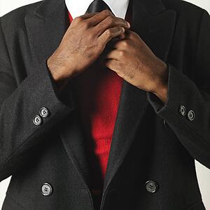 Close up of man fixing his necktie