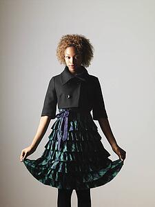 Woman in pretty ruffled dress holding the hem out to sides