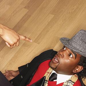 Man on back on floor with woman pointing accusingly