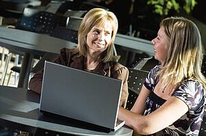 Two women working on a laptop