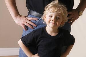 Boy with adult standing behind