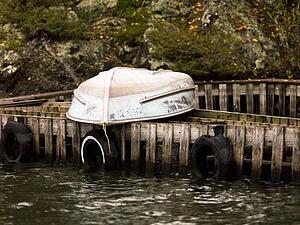 A boat resting upside down on a dock