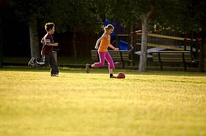 Two kids playing soccer