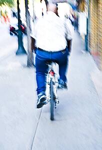 Rear view of man riding bike