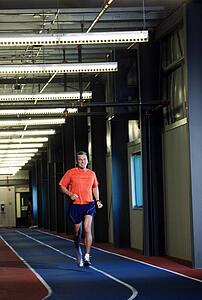 Man running on an indoor track