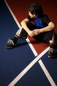Boy sitting on a race track