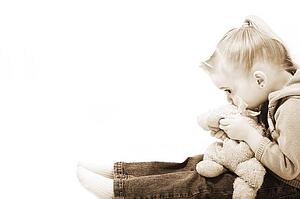 Girl holding her teddy bear