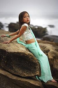 Girl leaning on a large rock