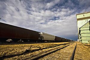 Train beside old grain elevators