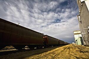 Train beside old grain elevators