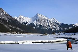 Man taking a picture of Medicine Lake, Alberta, Canada