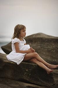 Girl sitting on a rock