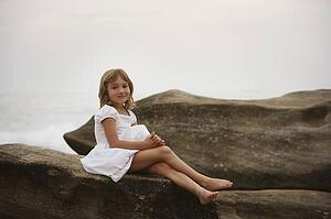 Girl posing on a large rock