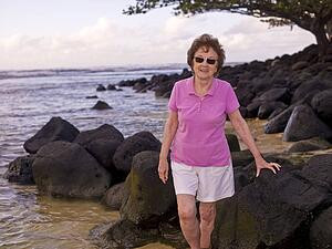 Woman on a rocky beach, Kauai, Hawaii, USA