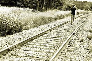 Man walking on train tracks