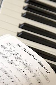 Close up of sheet music on piano keyboard