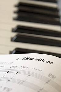 Book of music open on piano, close up