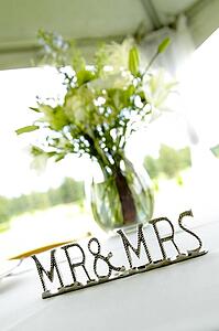 'Mr & Mrs' sign next to vase on table