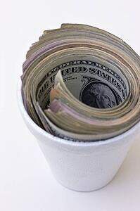American paper currency in styrofoam cup
