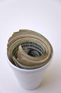 American paper currency in styrofoam cup