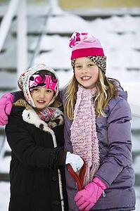 Portrait of two girls in winter clothes
