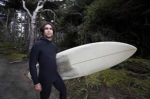 Surfer by forest