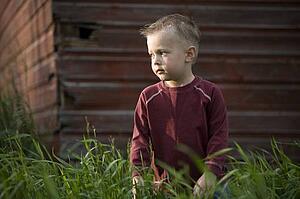 A young boy in tall grass