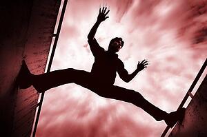 Man stretching between two walls