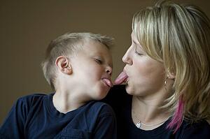 Mother and son sticking tongue out