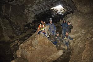 Climbers cheering in cave, Cadomin, Alberta, Canada