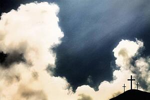 Three crosses on hill and dramatic clouds