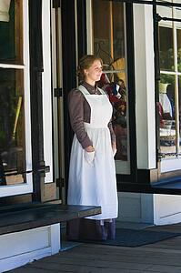 Young woman standing in store doorway 